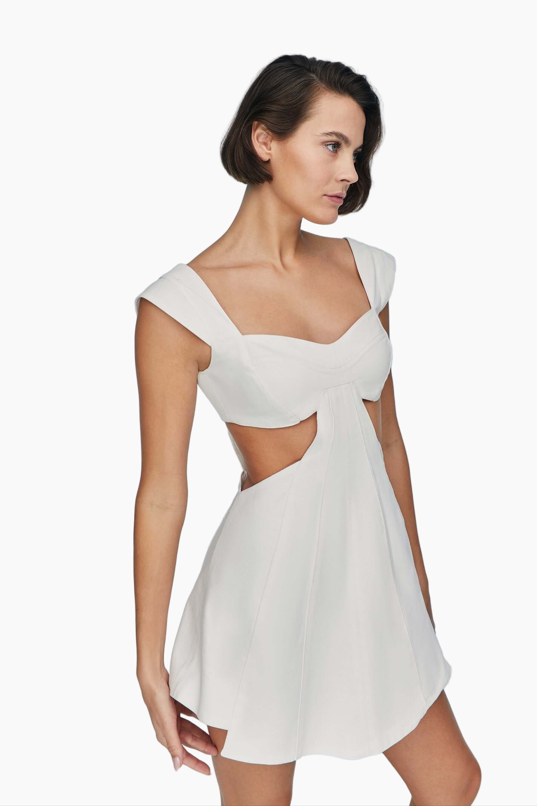 Woman wearing a white dress with cut-out design