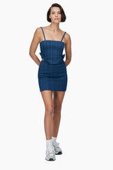 women wearing a mini denim skirt, Secured with a metallic zipper. Vertical patterns with a matching top.