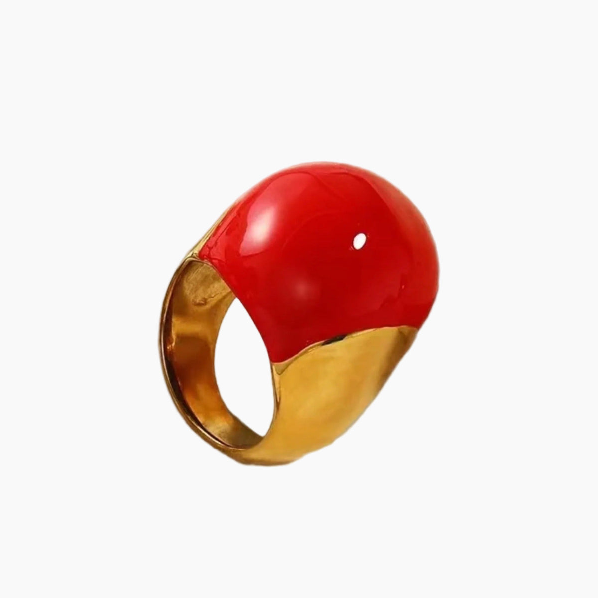 Ring with red gemstone and gold band on a white background
