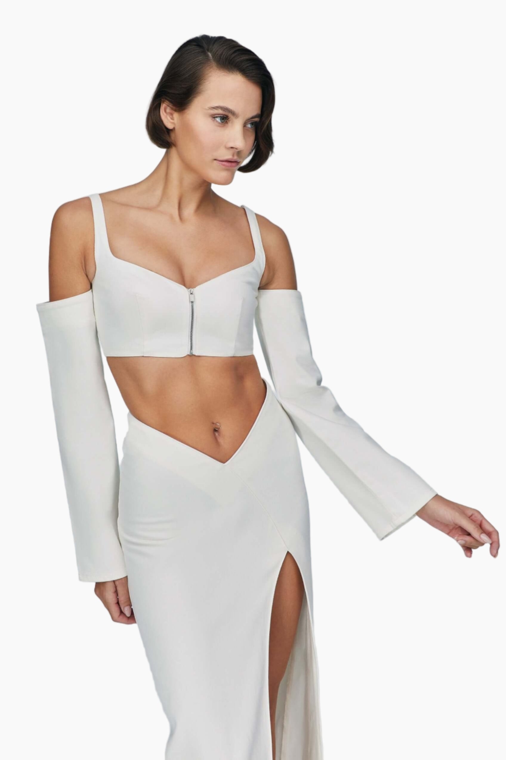 Woman wearing a white denim top with long sleeves and a high slit skirt