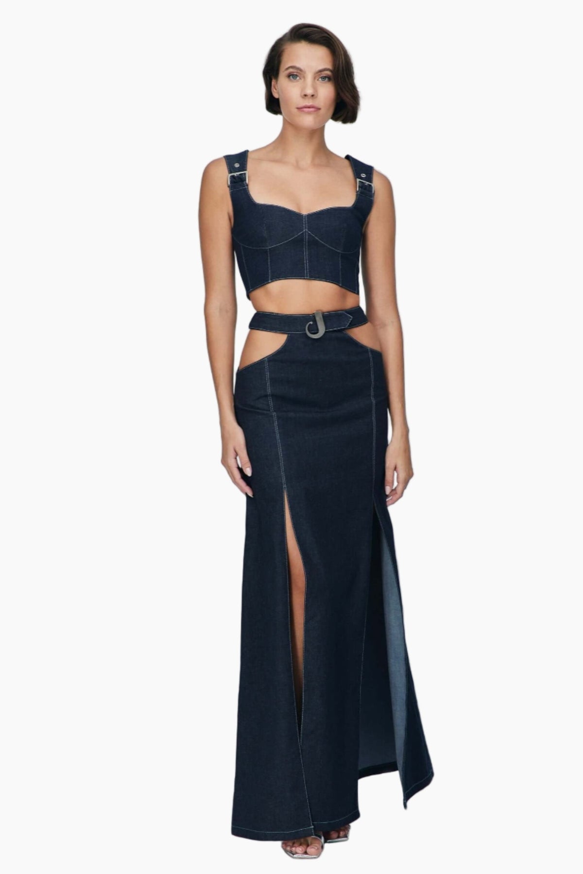 women wearing a sleeveless denim crop top with a matching denim maxi skirt, Lycra denim, features cut outs under the belt and a side slit.