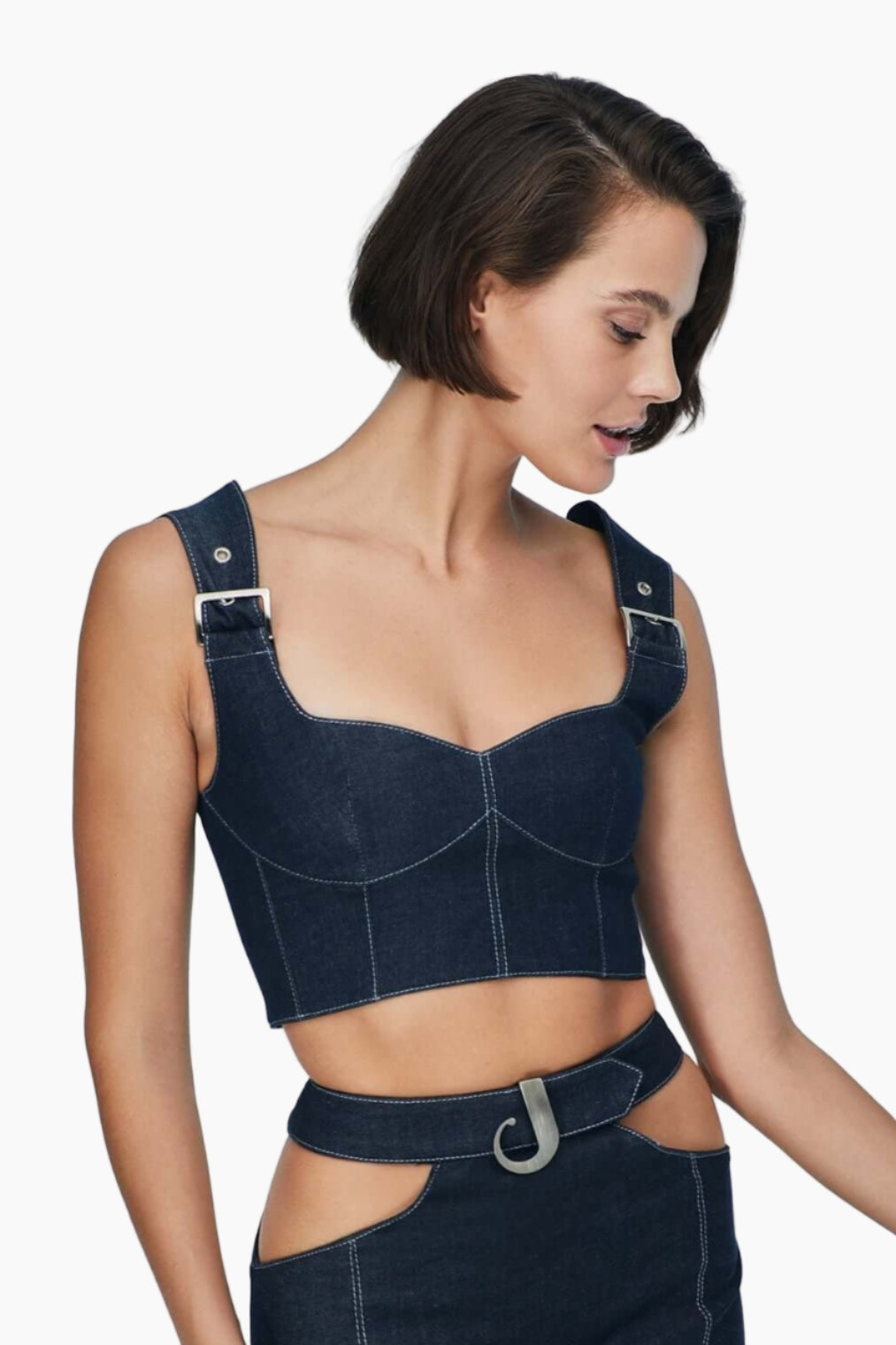 women wearing a crop top crafted from denim, this top feature chic belt-like straps, elegant bustier neckline and chic corset shape.