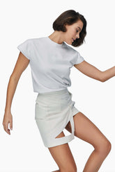 Woman wearing a white t-shirt and  denim mini skirt