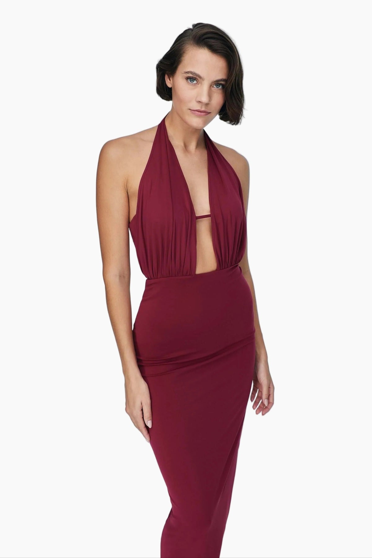 Woman wearing a burgundy halter neck dress