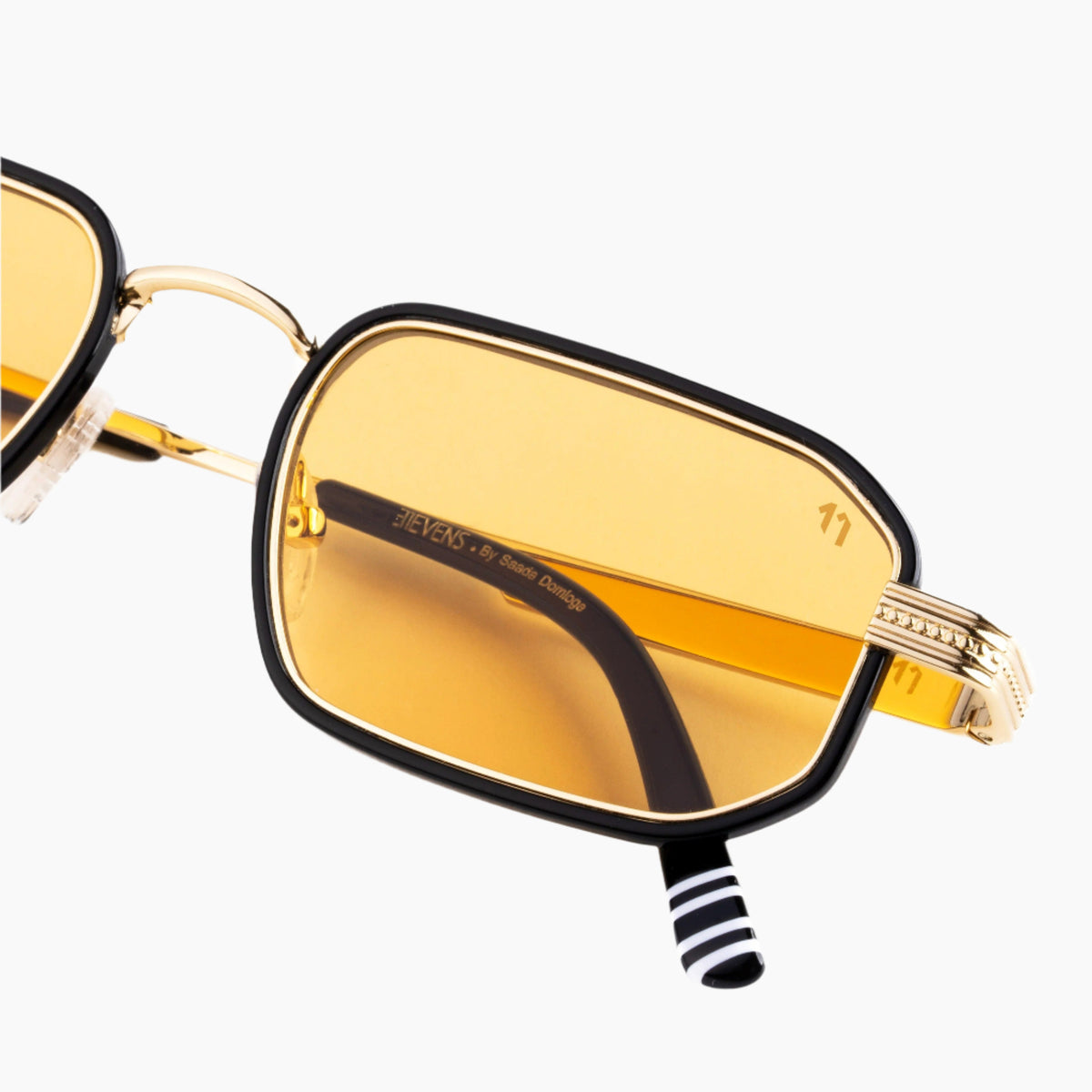 Sunglasses with gold lenses and black frames on a white background