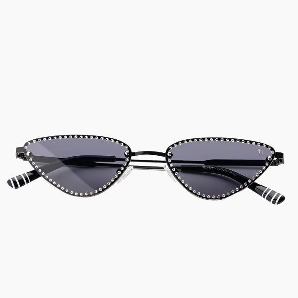 Cat-eye sunglasses with black frames and dark lenses on a white background