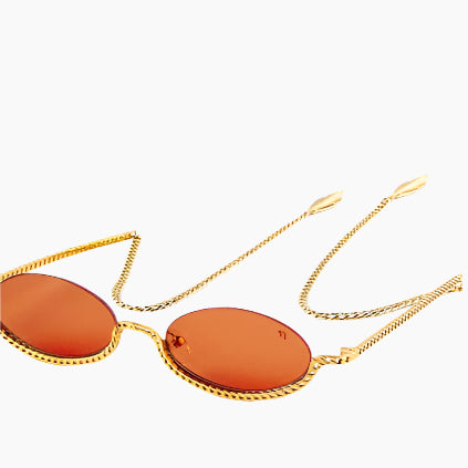 Sunglasses with orange lenses and gold chain