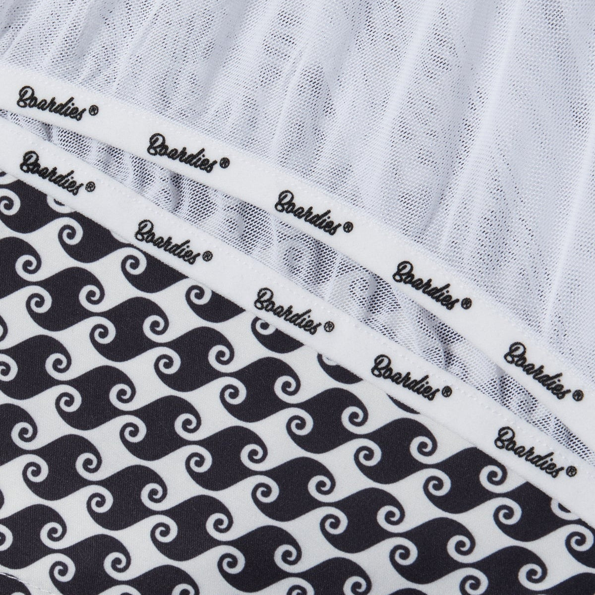 White t-shirt with black wave pattern and 'Boardies' branding