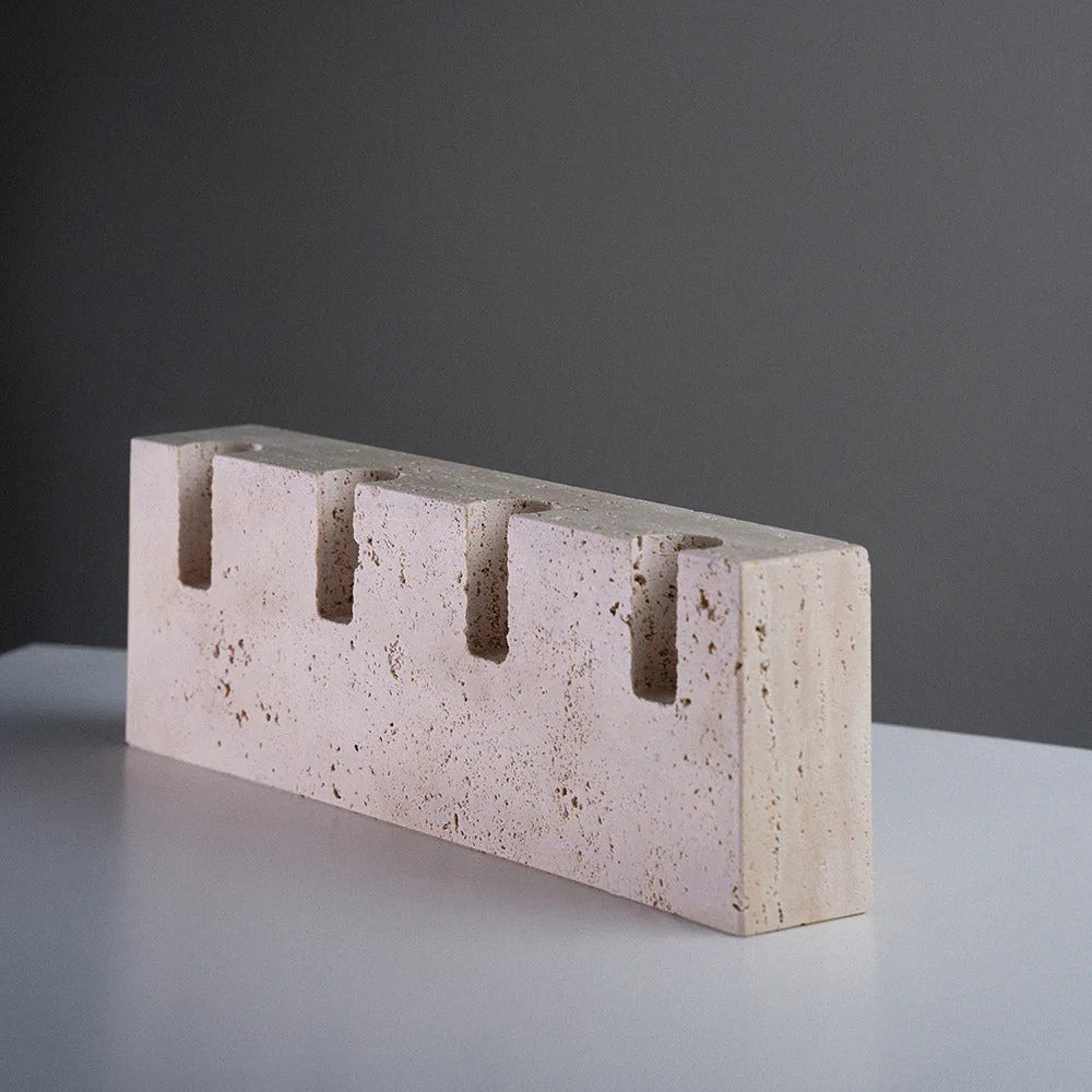 Concrete brick with rectangular shape and vertical holes on a gray background