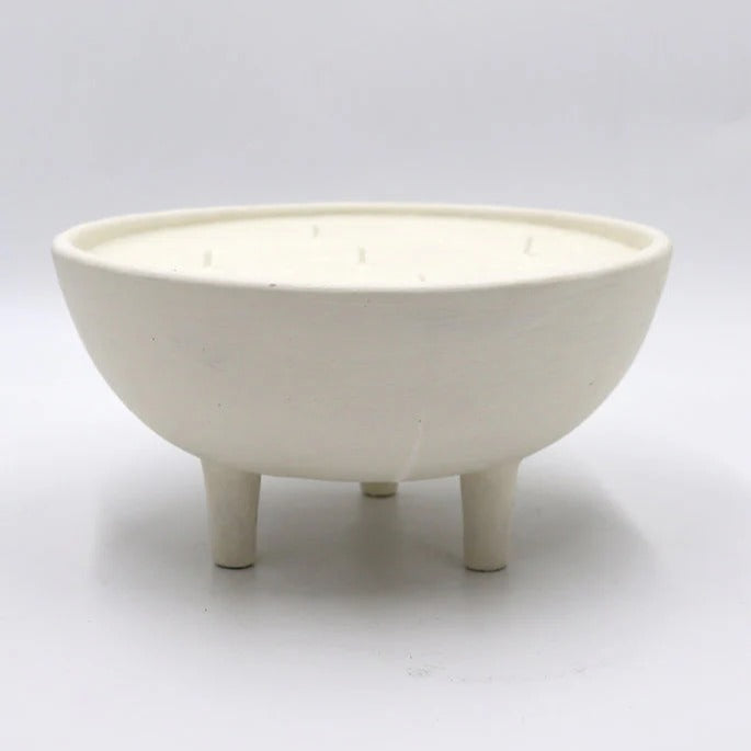White ceramic bowl with three legs on a light gray background