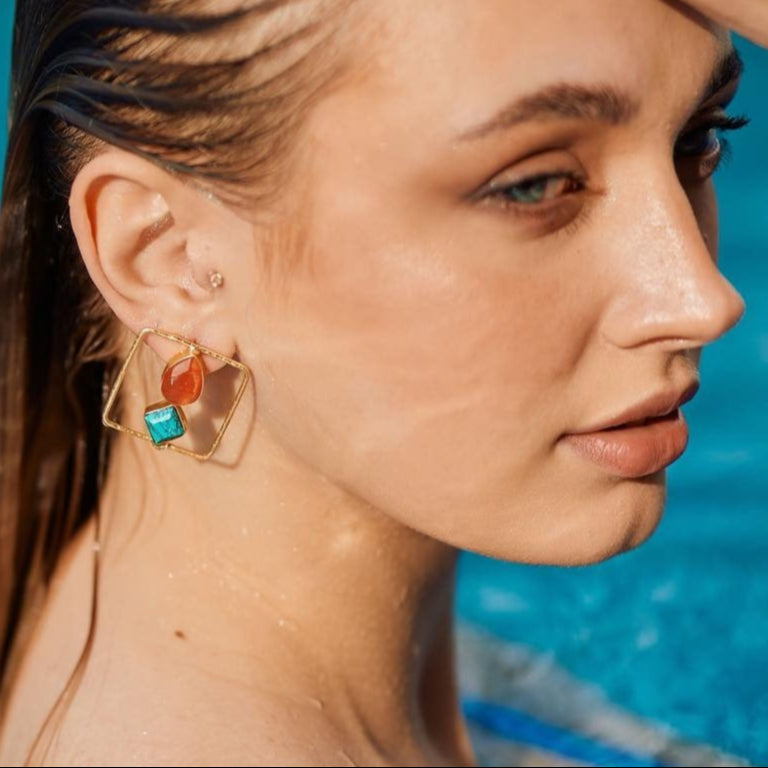 Woman with wet hair standing by a pool