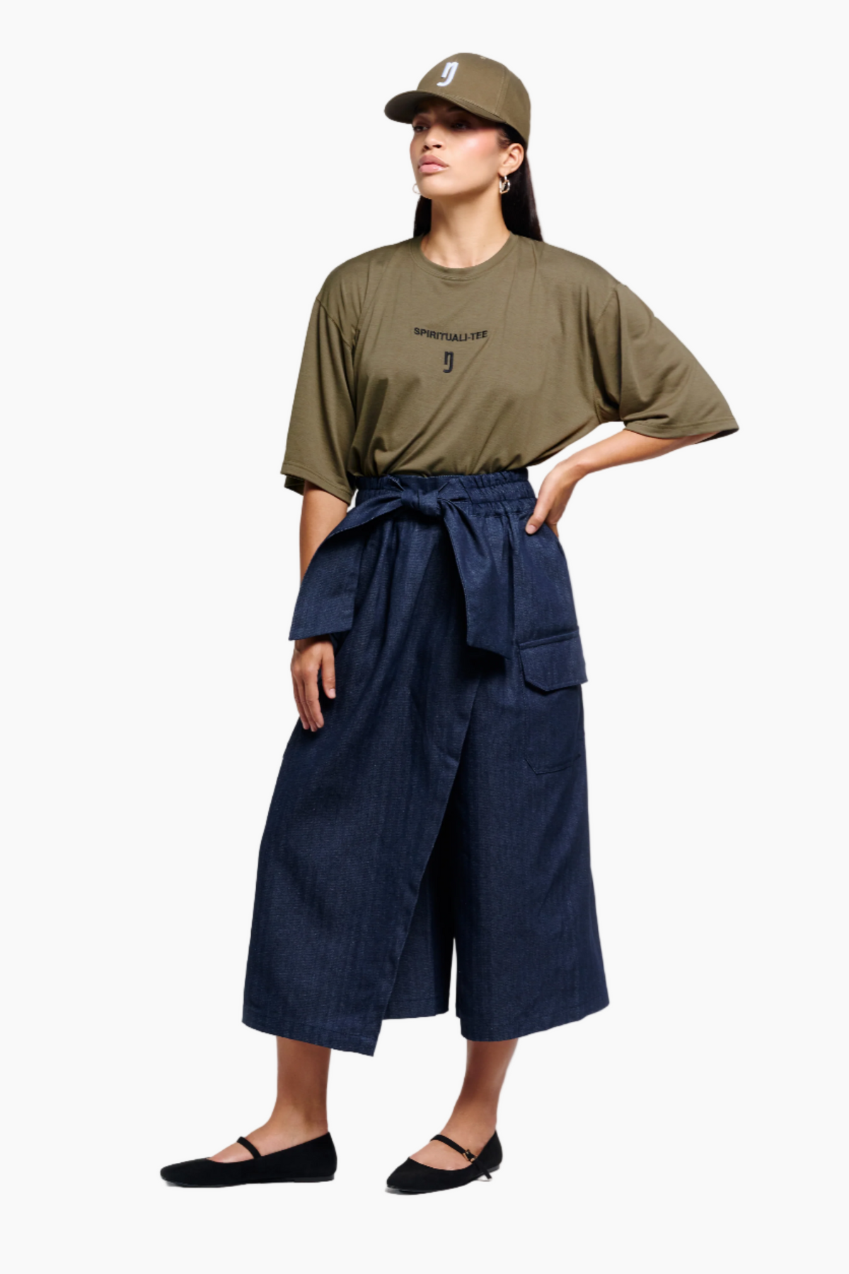 Person wearing an olive green t-shirt and navy blue pants on a white background