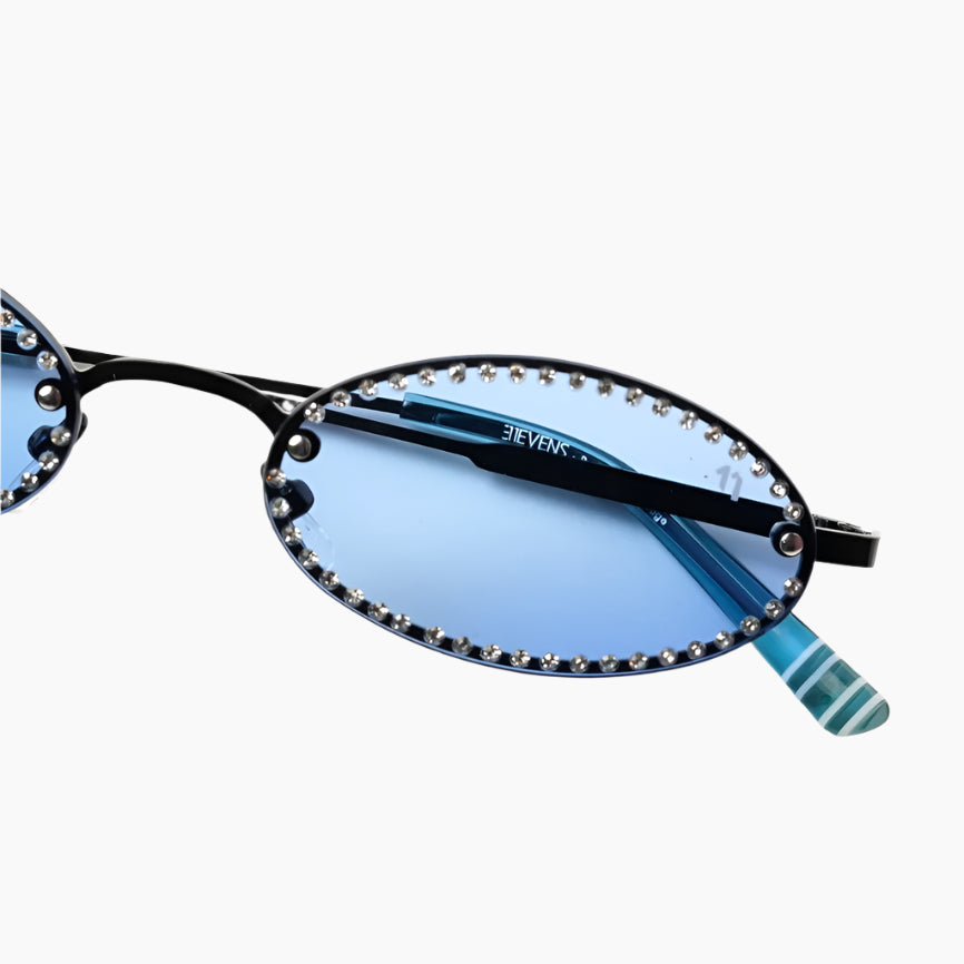 Black-rimmed sunglasses with blue lenses on a white background