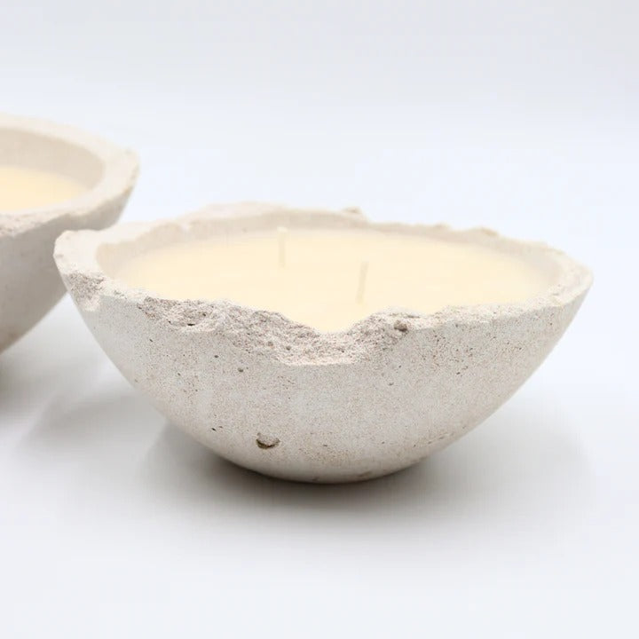 Two stone-like bowls with candles inside