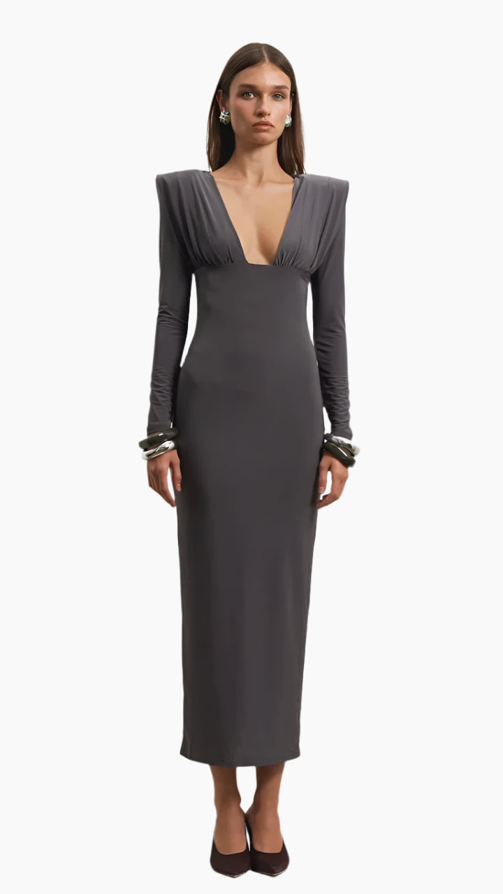 Woman wearing a gray evening gown with long sleeves