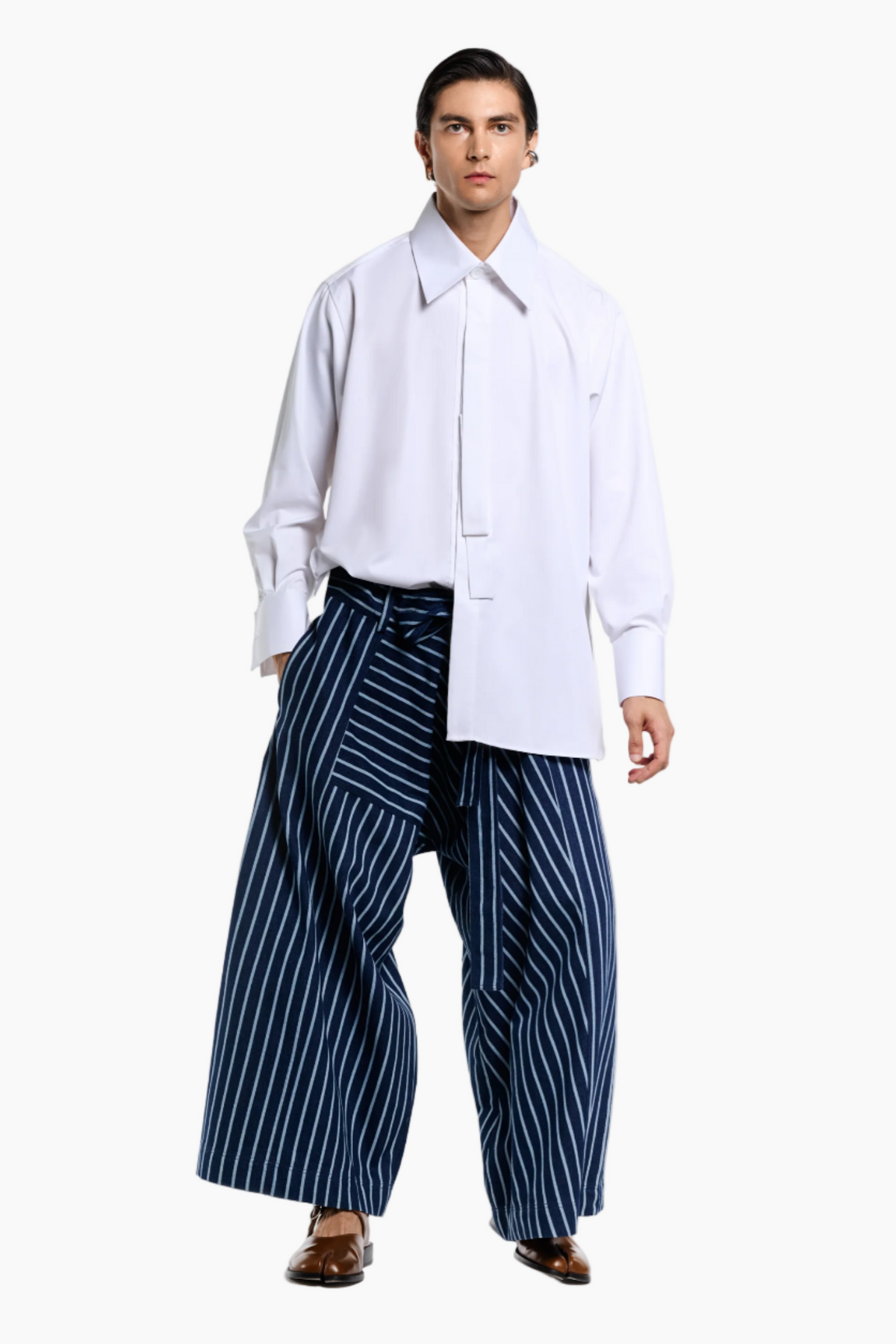 Person wearing a white shirt and blue striped pants on a white background