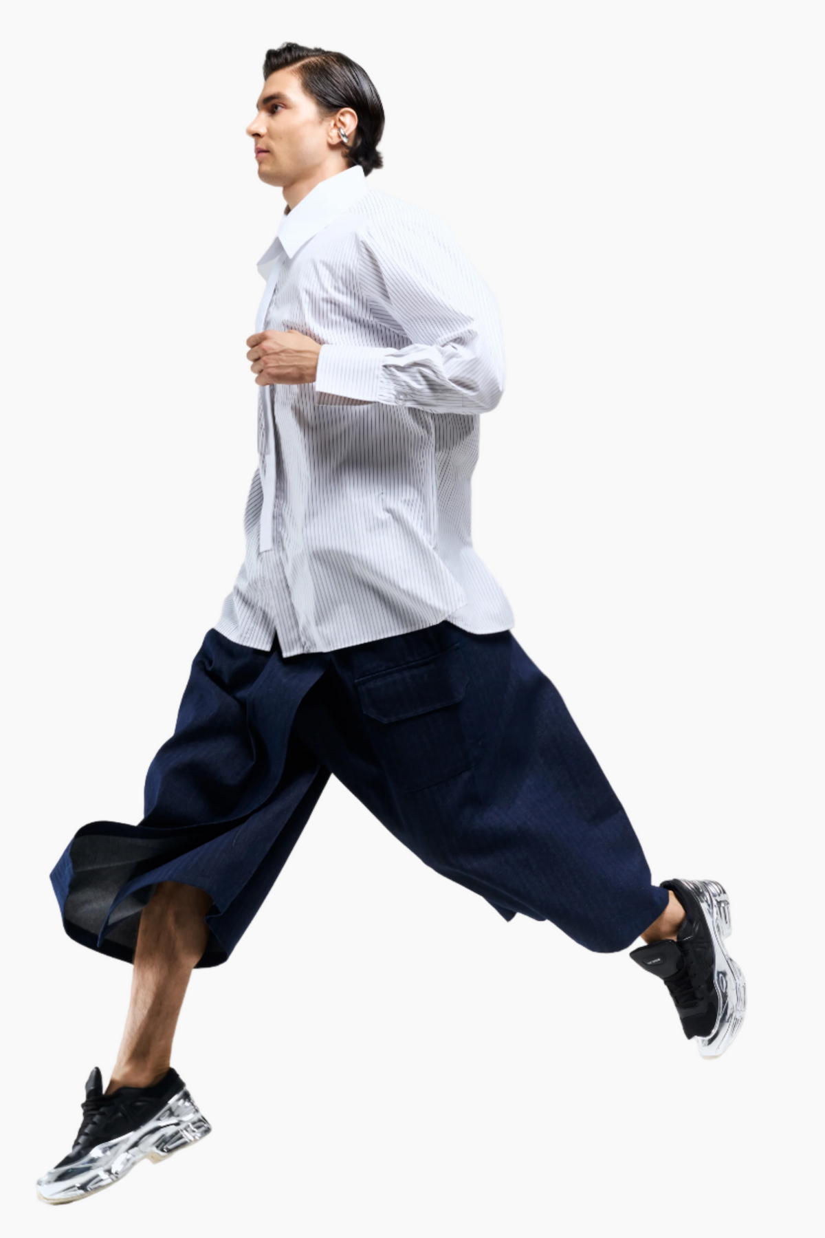 Person wearing a white shirt and navy pants running on a light gray background