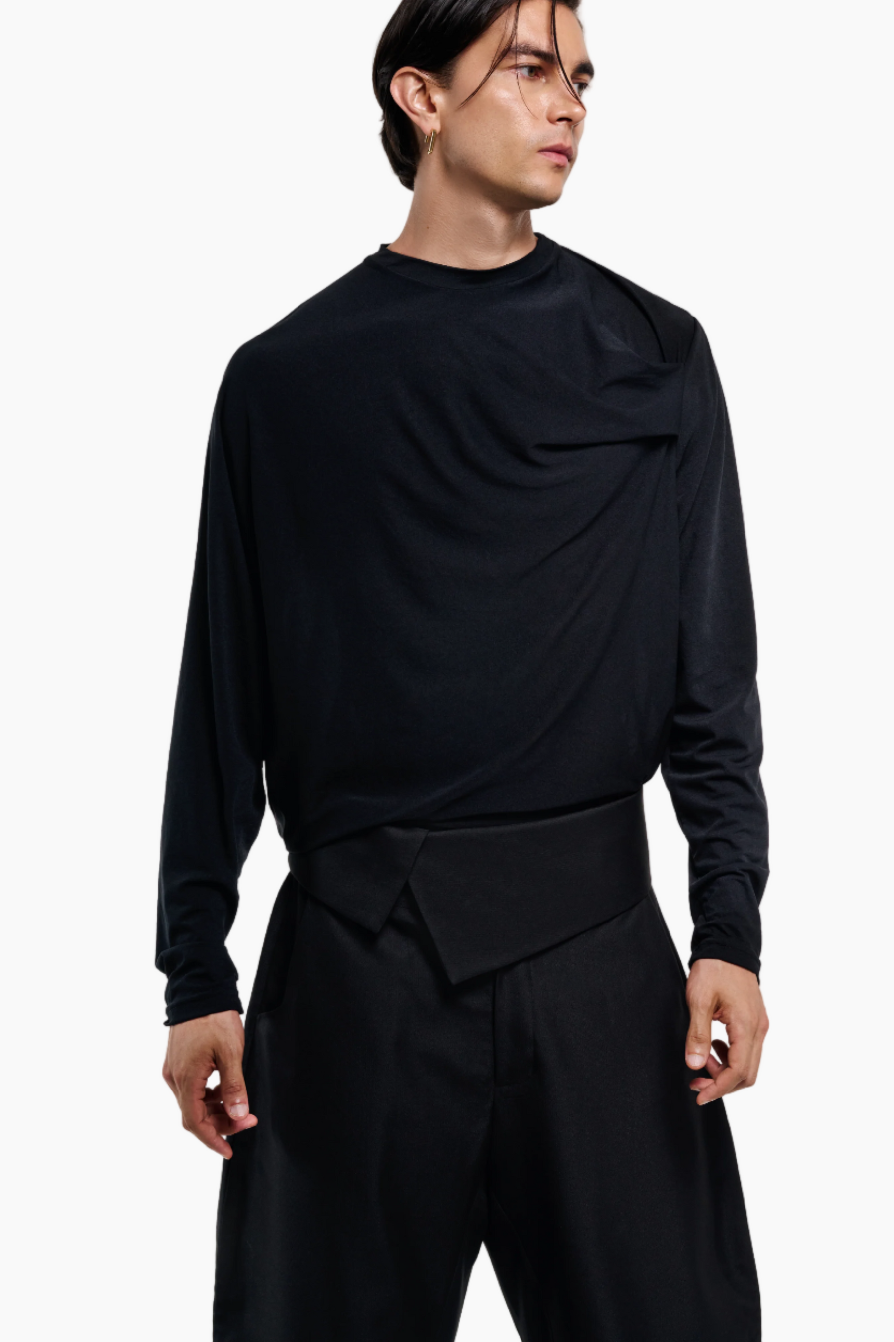 Person wearing a black outfit black draped and pants