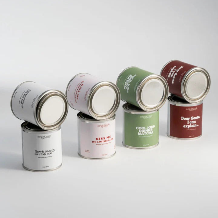 Set of paint cans with various labels on a light gray background