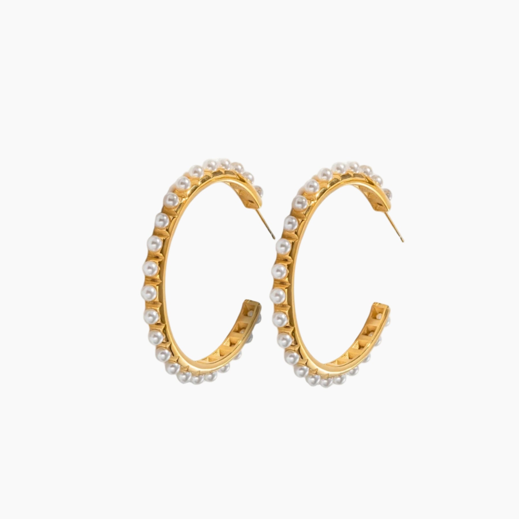 Gold hoop earrings with embedded pearls on a white background