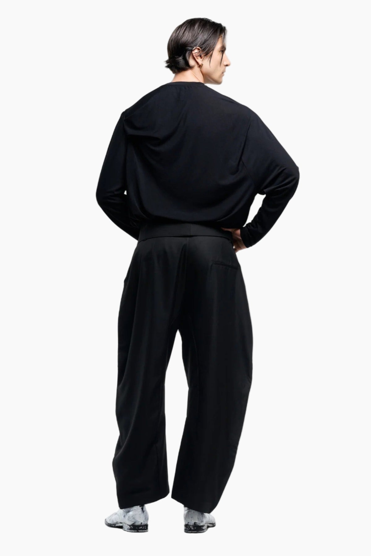 Person wearing a black outfit on a white background