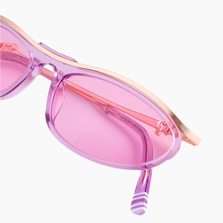 Pink sunglasses with a gold frame on a white background
