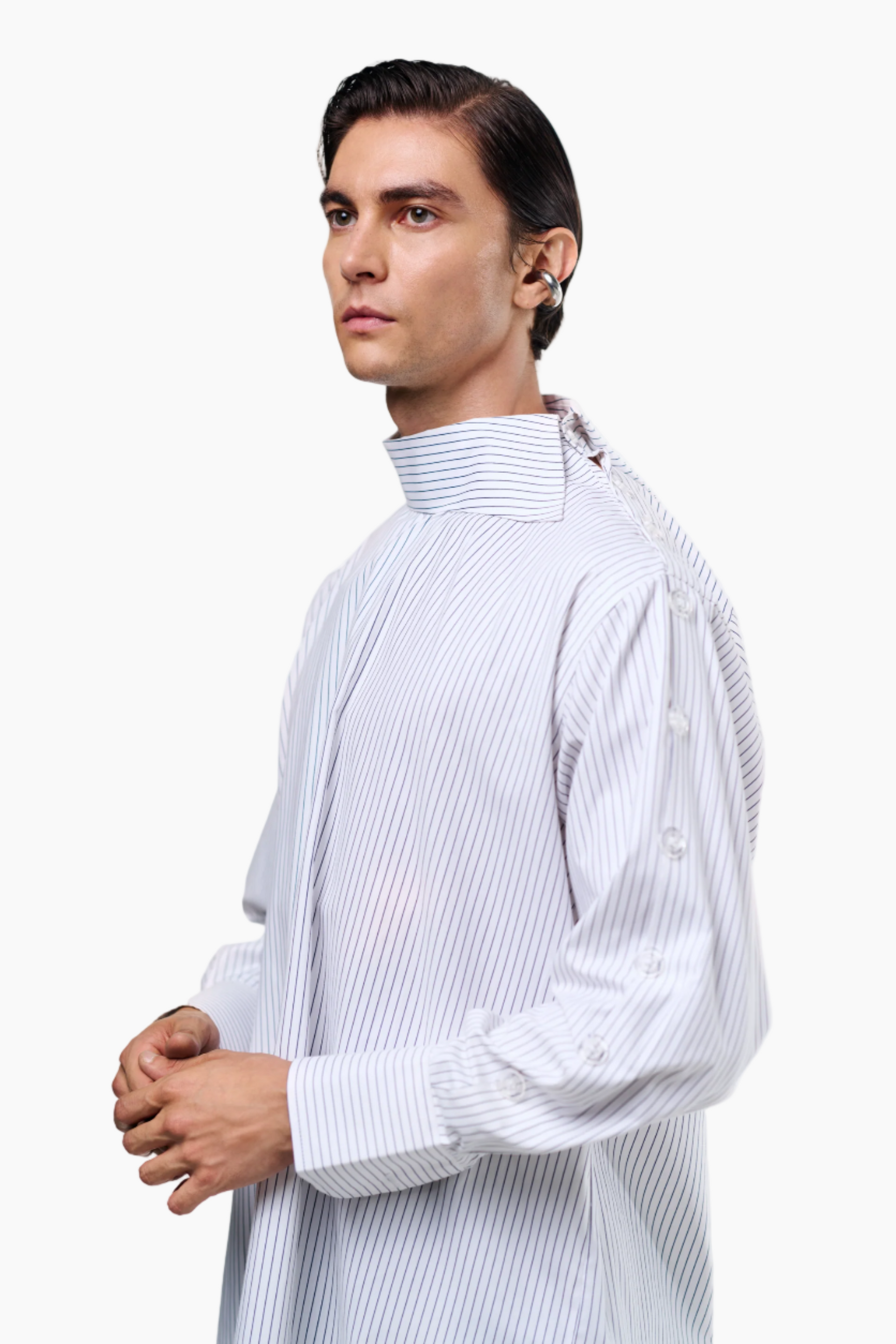 Man wearing a light gray striped shirt against a white background