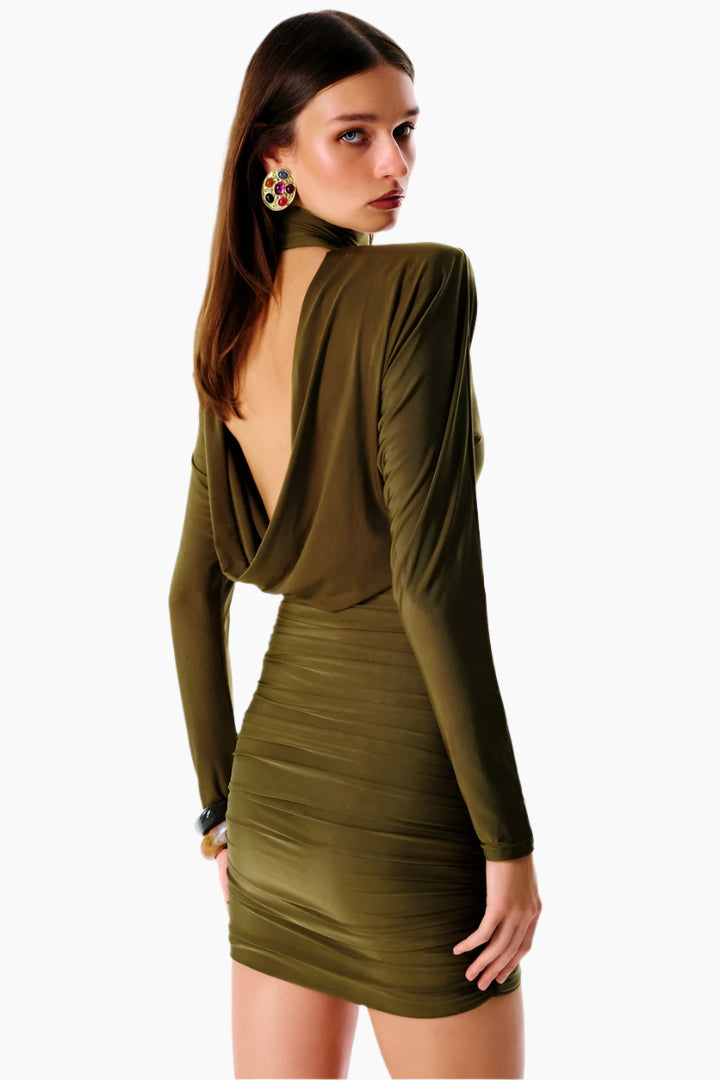 Woman wearing a green dress with a backless design