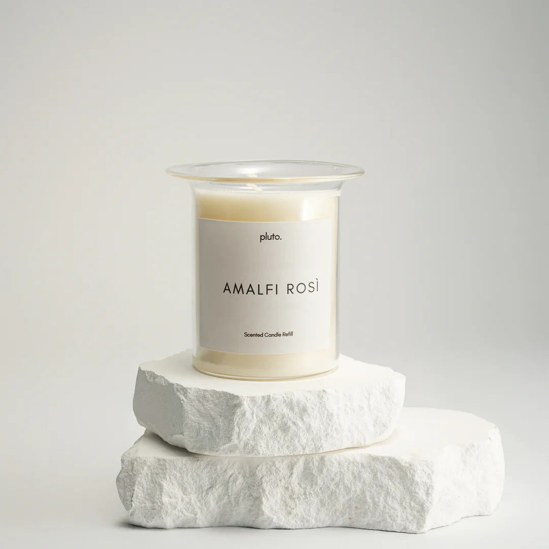 Candle labeled 'Amalfi Rosá' on a white stone block