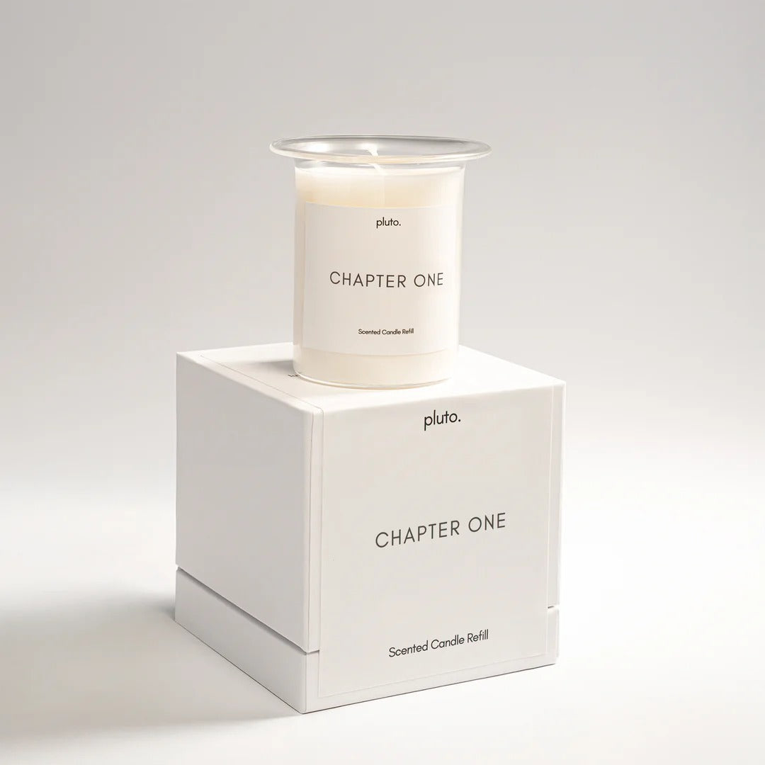 Candle labeled 'Chapter One' by Pluto on a white box with the same label.