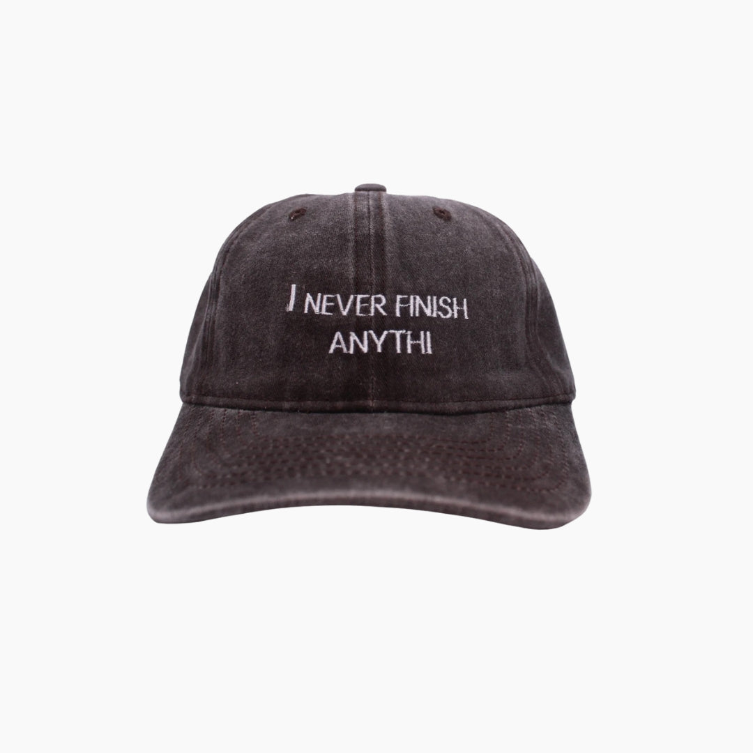 Black cap with 'I NEVER FINISH ANYTHI' text