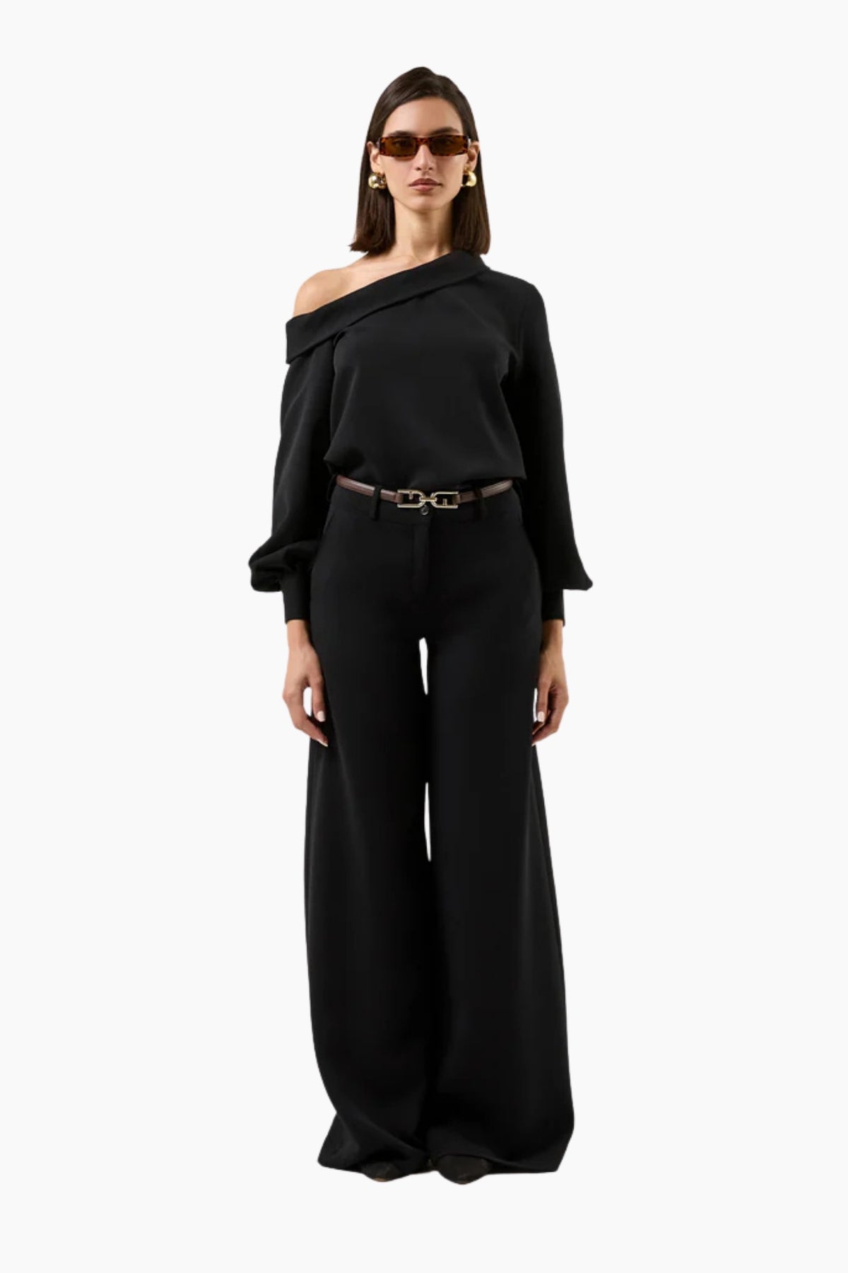 Woman wearing a black off-shoulder top and wide-leg pants