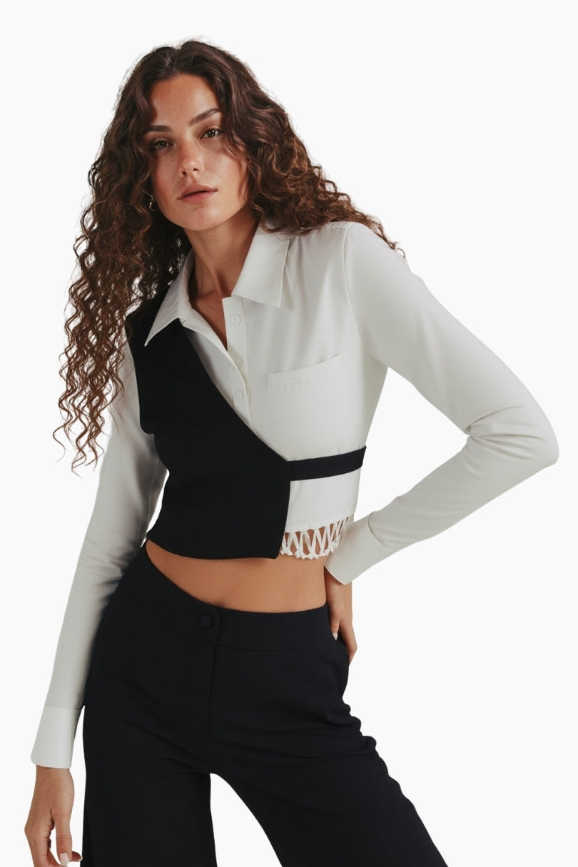 Woman wearing a white long-sleeve top with black accents on a white background