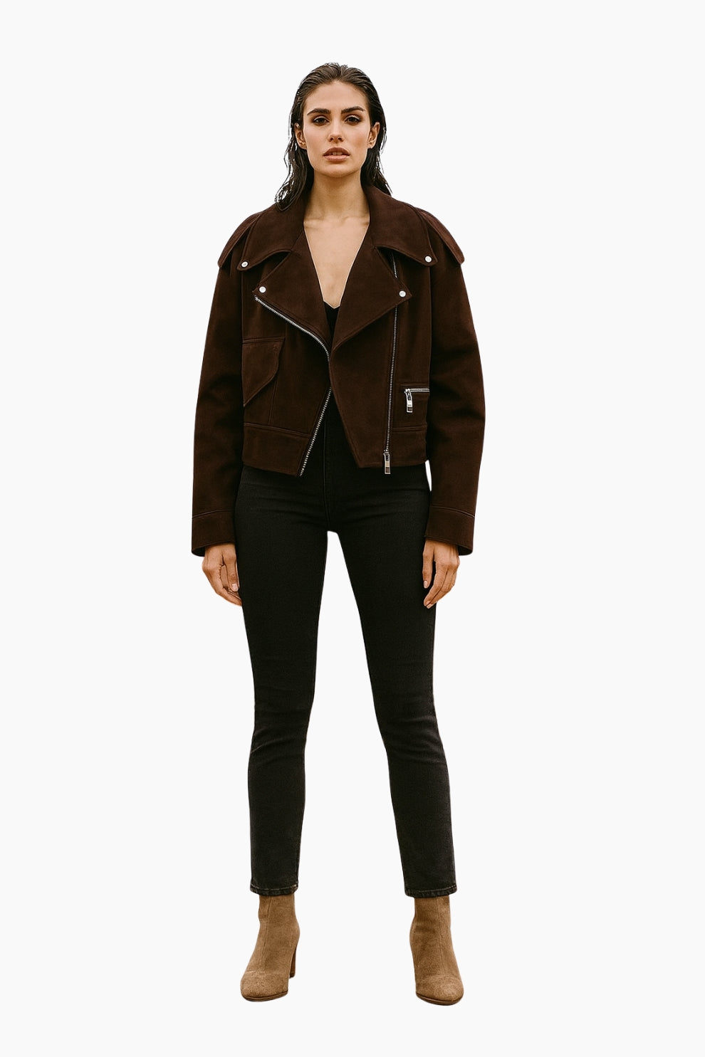 Woman wearing a brown jacket, black pants, and brown boots