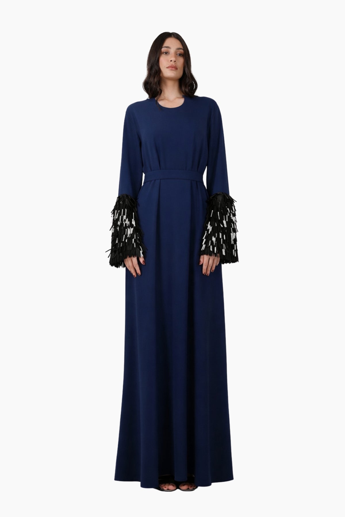 Navy blue dress with intricate cuffs on a white background