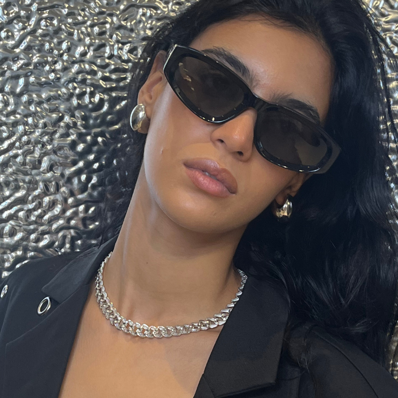 Woman wearing sunglasses and a black outfit