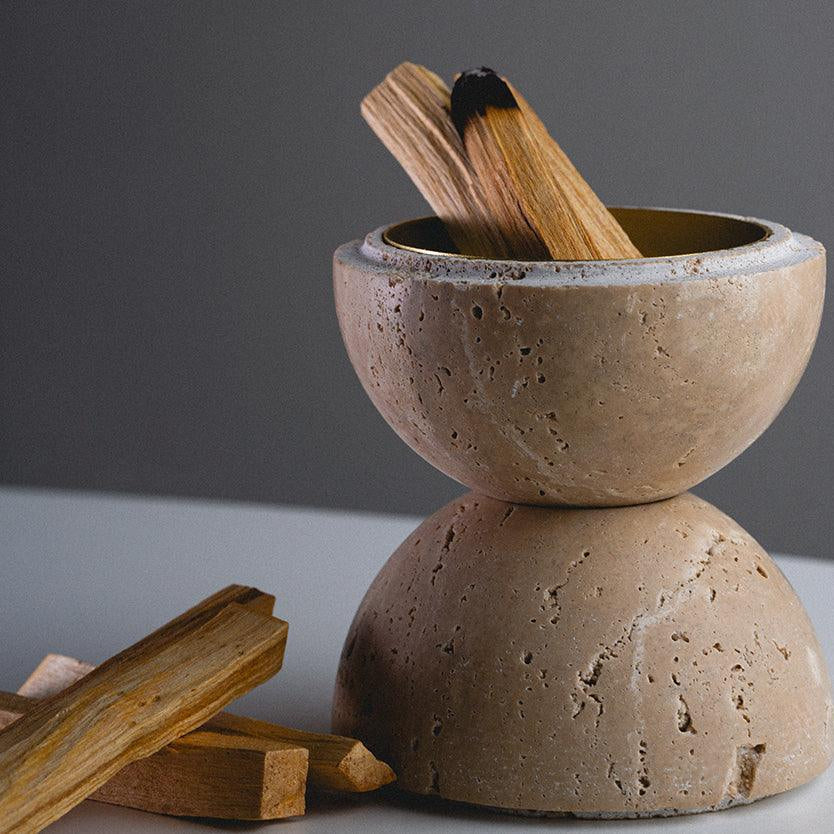 Nix insence burner - A hand-carved circular-shaped incense holder made of beige travertine with nine holes.