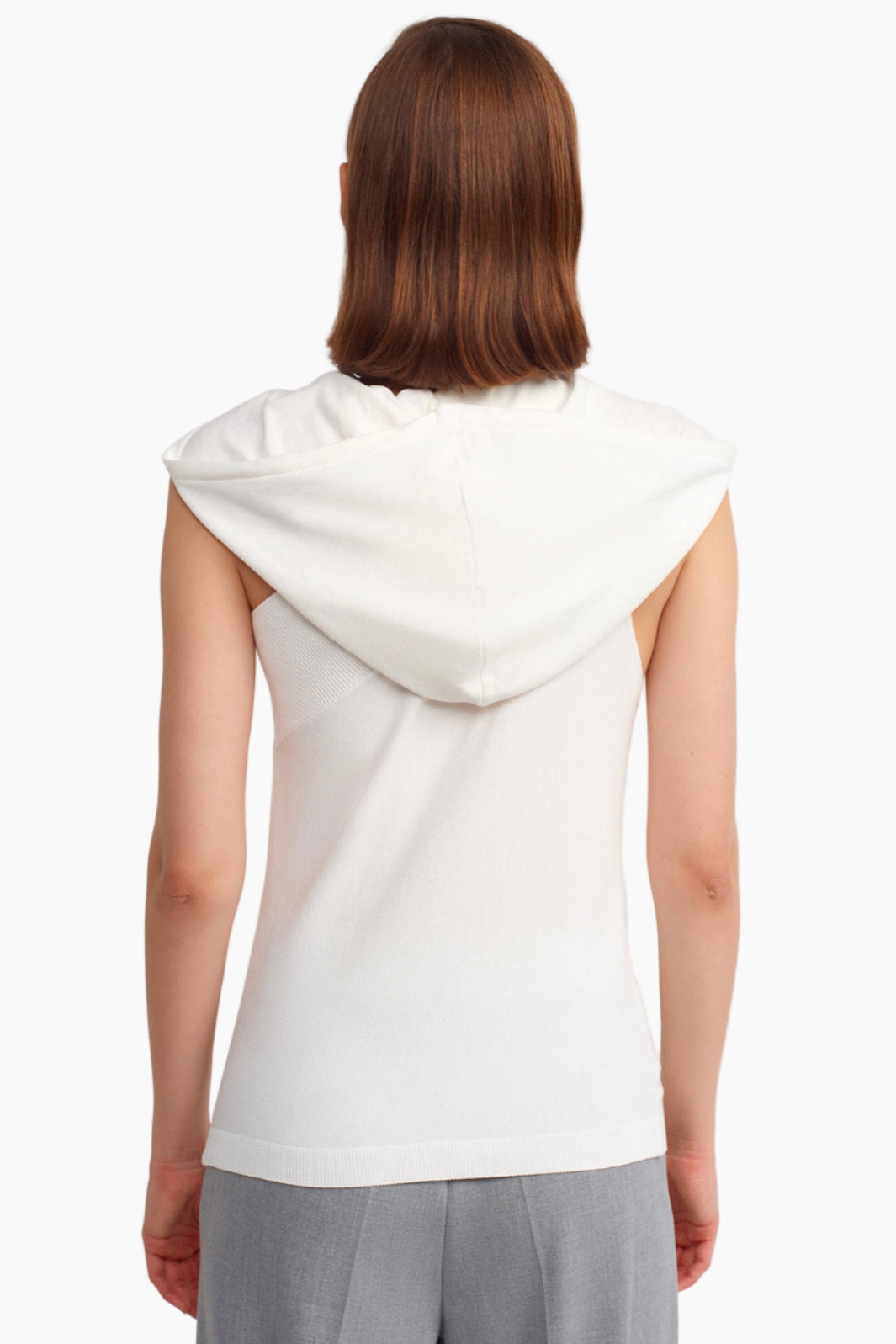 Person wearing a white sleeveless hoodie on a white background