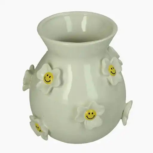 White ceramic vase with smiley face daisies