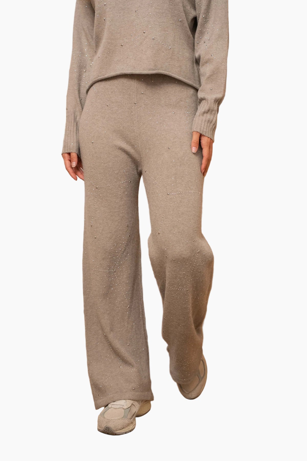 Person wearing a beige sweater and pants