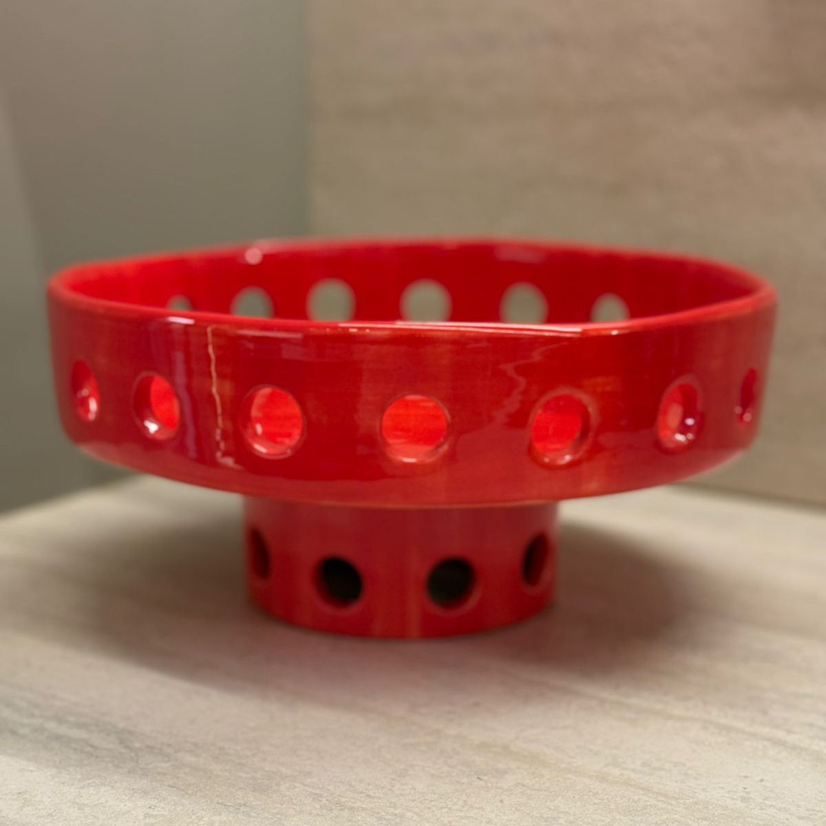 Red perforated bowl