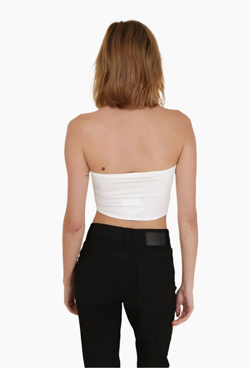 Woman wearing a white strapless top and black pants