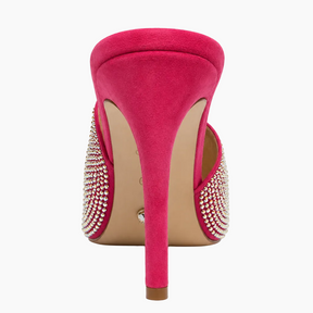 A single bright pink suede stiletto heel shoe shown from the back, featuring crystal-embellished side straps and a beige insole, set against a plain white background.