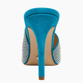 A single turquoise blue suede stiletto pump shown from the back, featuring silver rhinestone embellishments on the sides and a beige insole.
