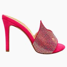 A single high-heeled mule sandal in bright pink suede, featuring a pointed toe embellished with dense multicolor rhinestones and a slim stiletto heel, shown against a plain white background.
