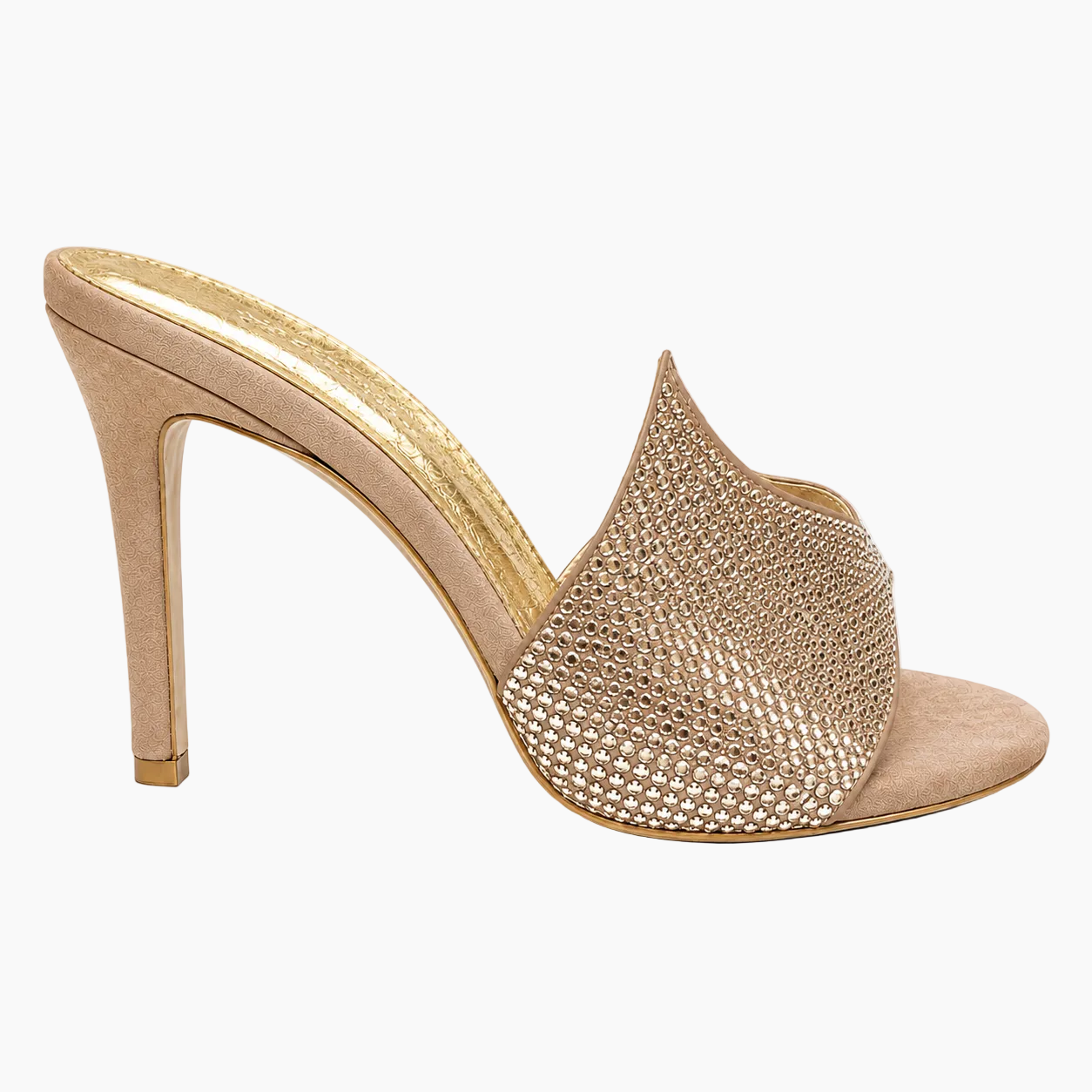 A single high-heeled mule sandal in a nude beige suede-like material, featuring a wide front strap covered in shimmering rhinestones, shown from a side profile on a white background.