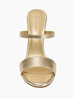 A single metallic gold heeled sandal with an ankle strap and a wide platform band, shown from the back on a white background. The brand name 'Heinz Vollenreuther' is printed on the insole.