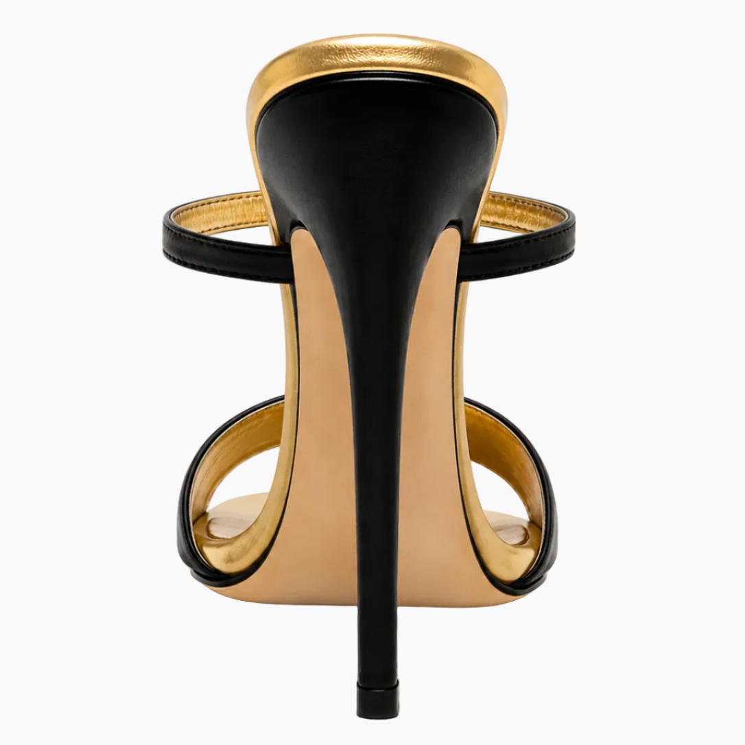 A single black and gold stiletto sandal shown from the back on a clean white background.
