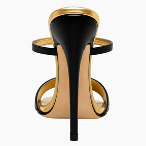 A single black and gold stiletto sandal shown from the back on a clean white background.