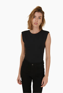 Woman wearing a black sleeveless top and black pants 